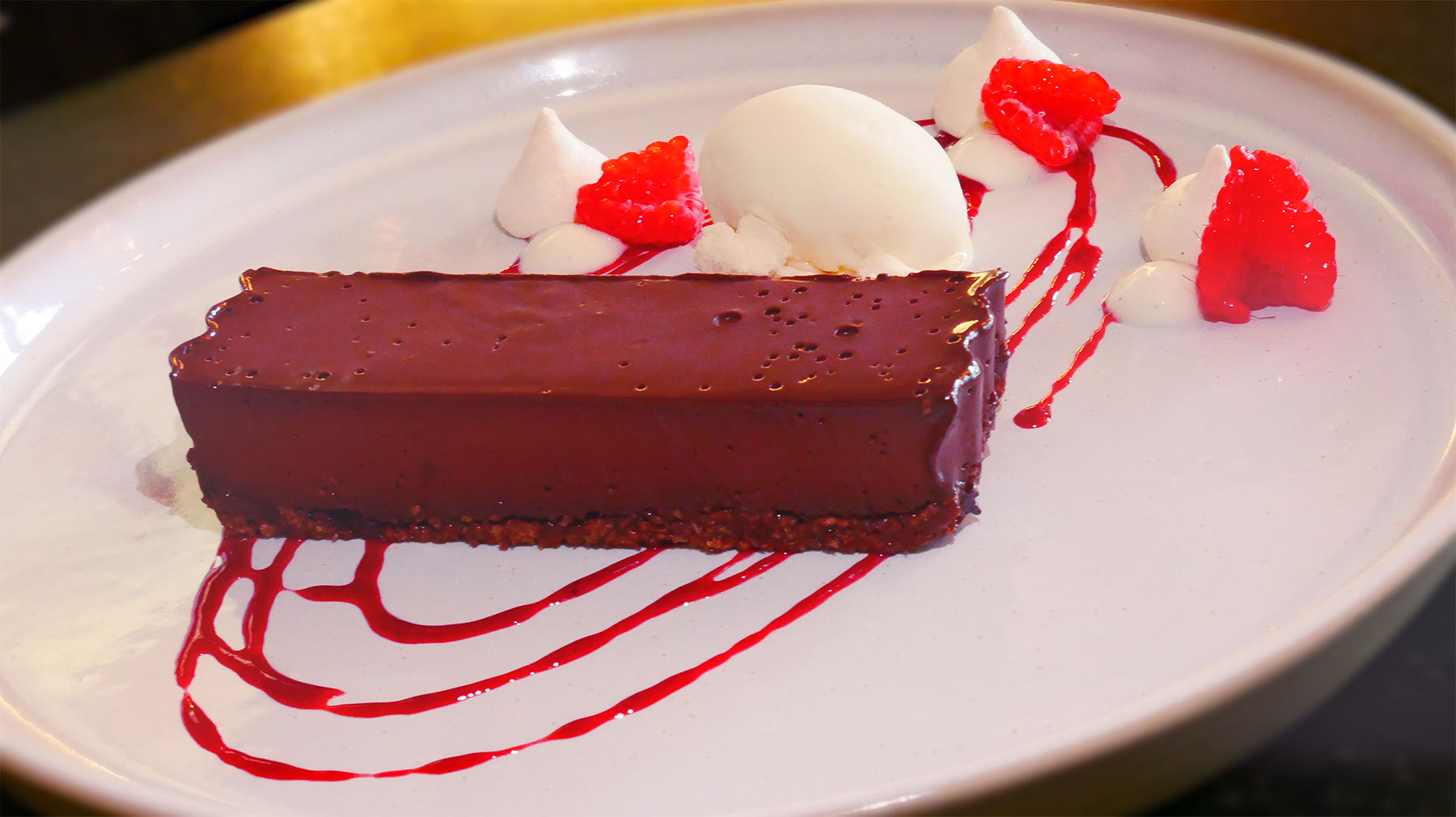 Chocolate dessert with raspberries and cream