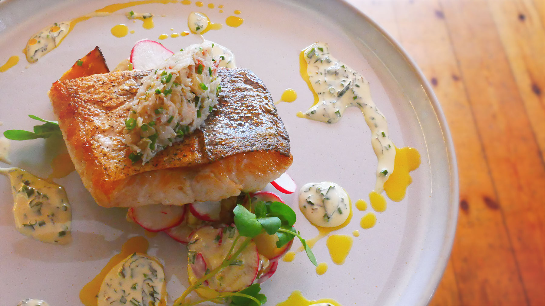 Crisp-skinned salmon topped with dressed crab